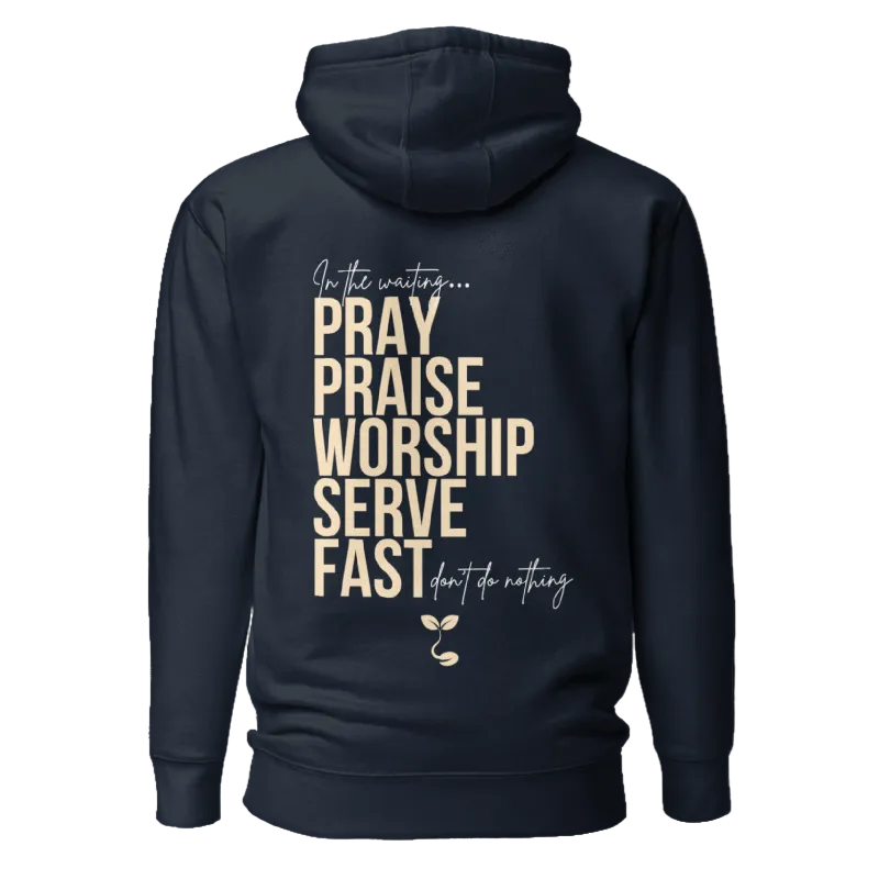 A navy blue hoodie shown from the back, featuring a motivational religious graphic with the words 'PRAY PRAISE WORSHIP SERVE FAST' in beige block letters, surrounded by smaller cursive text and a small sprout illustration.